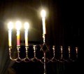 Three lit Chanukah candles plus the Shamash candle