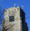 Face of church tower with clock and no steeple