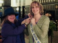 Judy pinning the sash on Kay