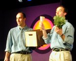 One of the guys holds the lettuce and pre-packaged salad