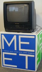 TV on a box that says M E E T