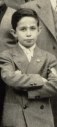 Young boy with arms crossed wearing a jacket
