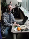 Dan with laptop and orange