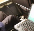 My row with my laptop and the feet of the person next to me