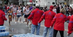 More runners and red coated water people