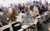 People sitting on chairs facing the podium in casual dress