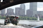 View under Longfellow bridge of a vehicle, skyline, and a sailboat