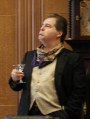 Actor looking up while holding martini glass