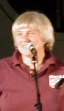 Sonny Ochs smiling at the audience