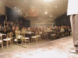 View from stage of tables with stage and ceiling visible