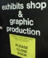 Sign on door: exhibits shop and graphic production