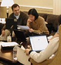 Students in easy chairs with laptops