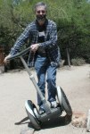 Dan on a Segway with one wheel up a few inches on a rock
