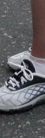 Running shoe with little black thing in the white laces