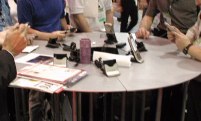 People around a round table with phones