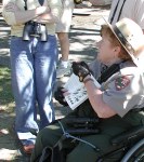 Park ranger in wheelchair holding bird book while we listen