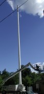 Pole against the blue sky with crane at bottom