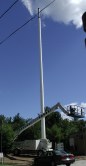 Pole against the blue sky with crane at bottom