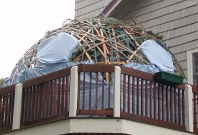 Dome made out of lots of slats of wood on porch