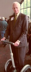 Man in suit on a Segway looking at the camera
