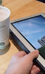 Cup of coffee from Starbucks, and Stonehenge background on a tablet