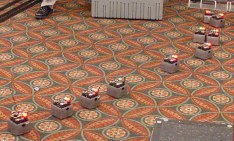 Robots rolling on the rug with red lights on