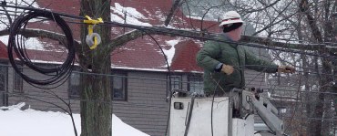 Coil of cable and man in cherry picker