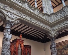 Ornate patio columns, organ, and tapestry